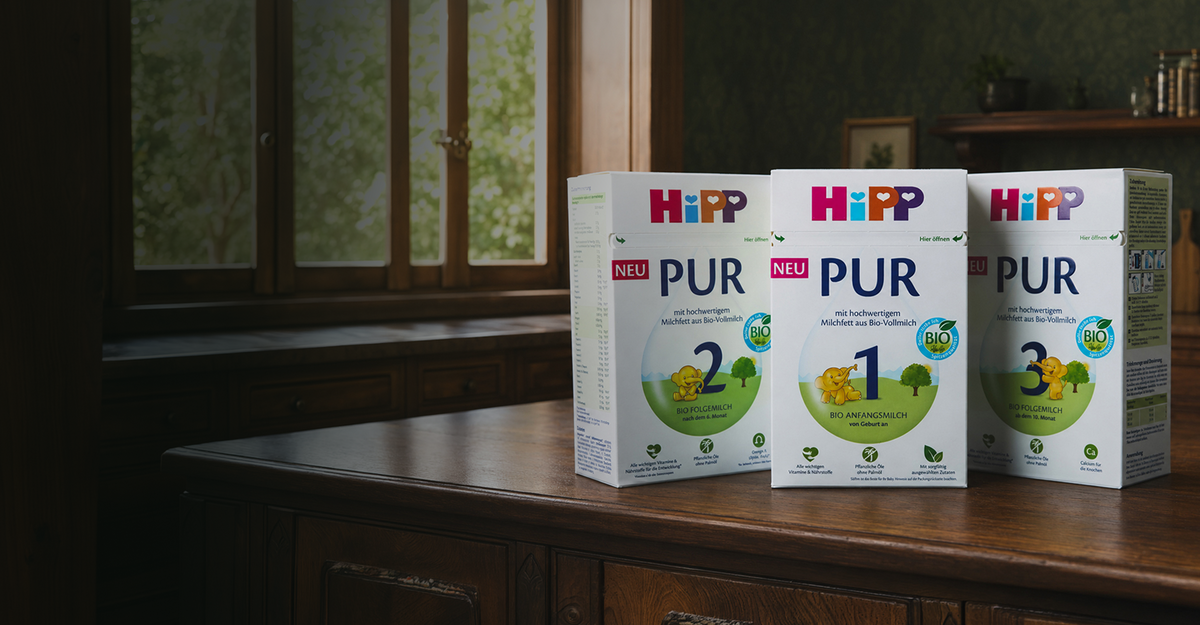 HiPP PUR Stage 1, 2 and 3 boxes on a wooden shelf