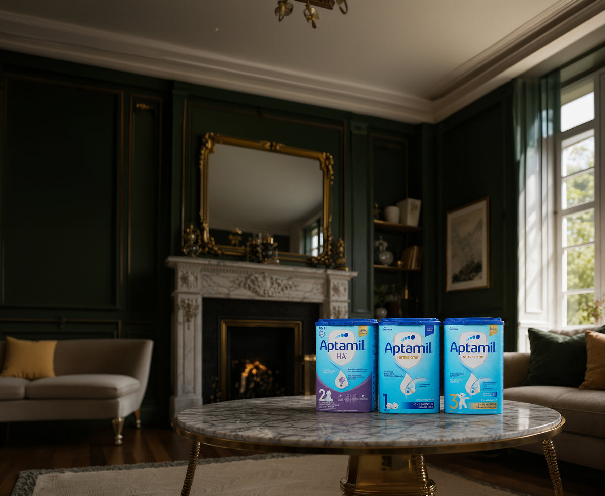 Aptamil HA, Nutribiotik Stage 1 and Stage 3 tins on a marble table